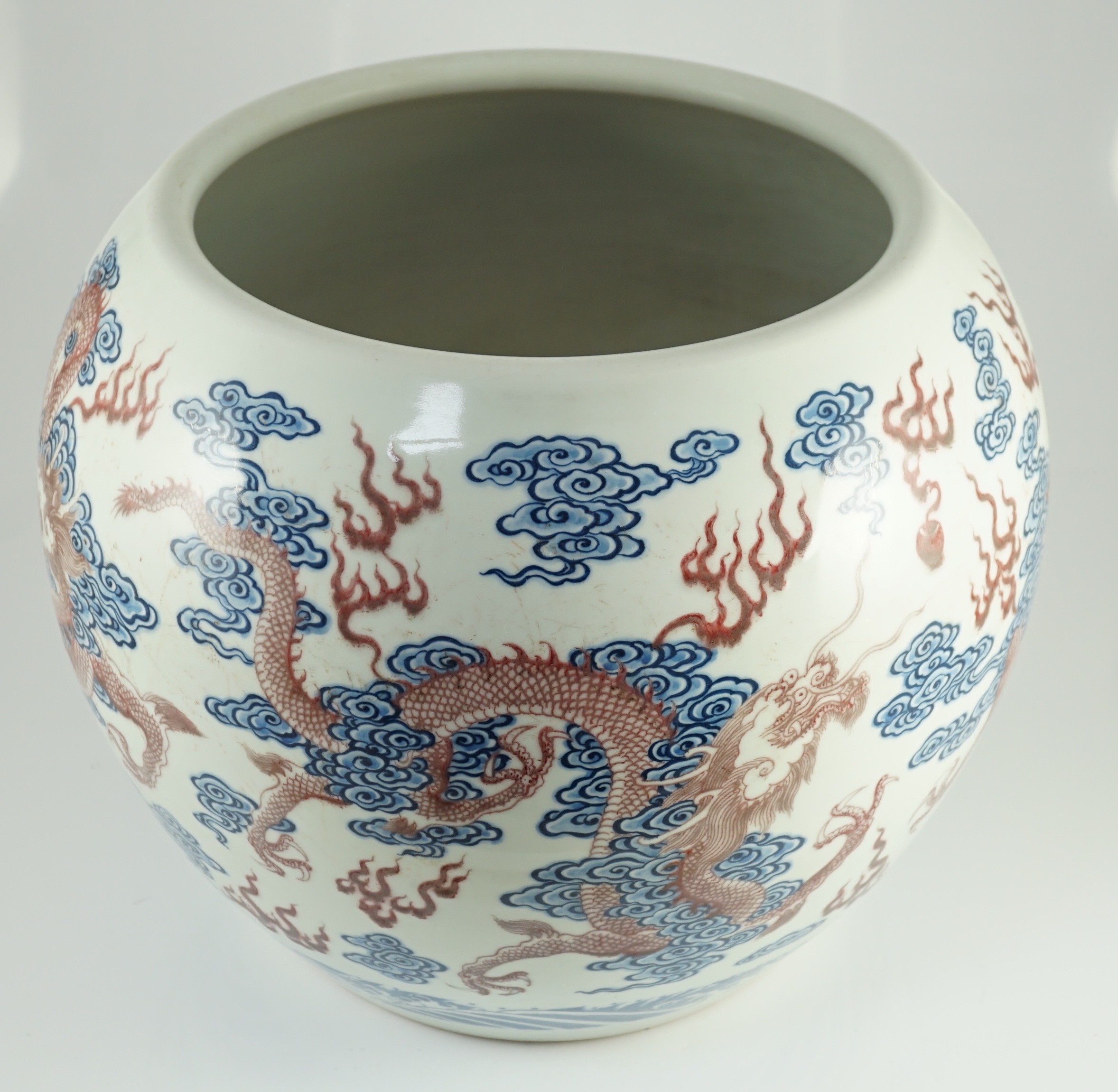 A large Chinese underglaze blue and copper red 'dragon' scroll vessel, 42.5cm diameter, 34.5cm high